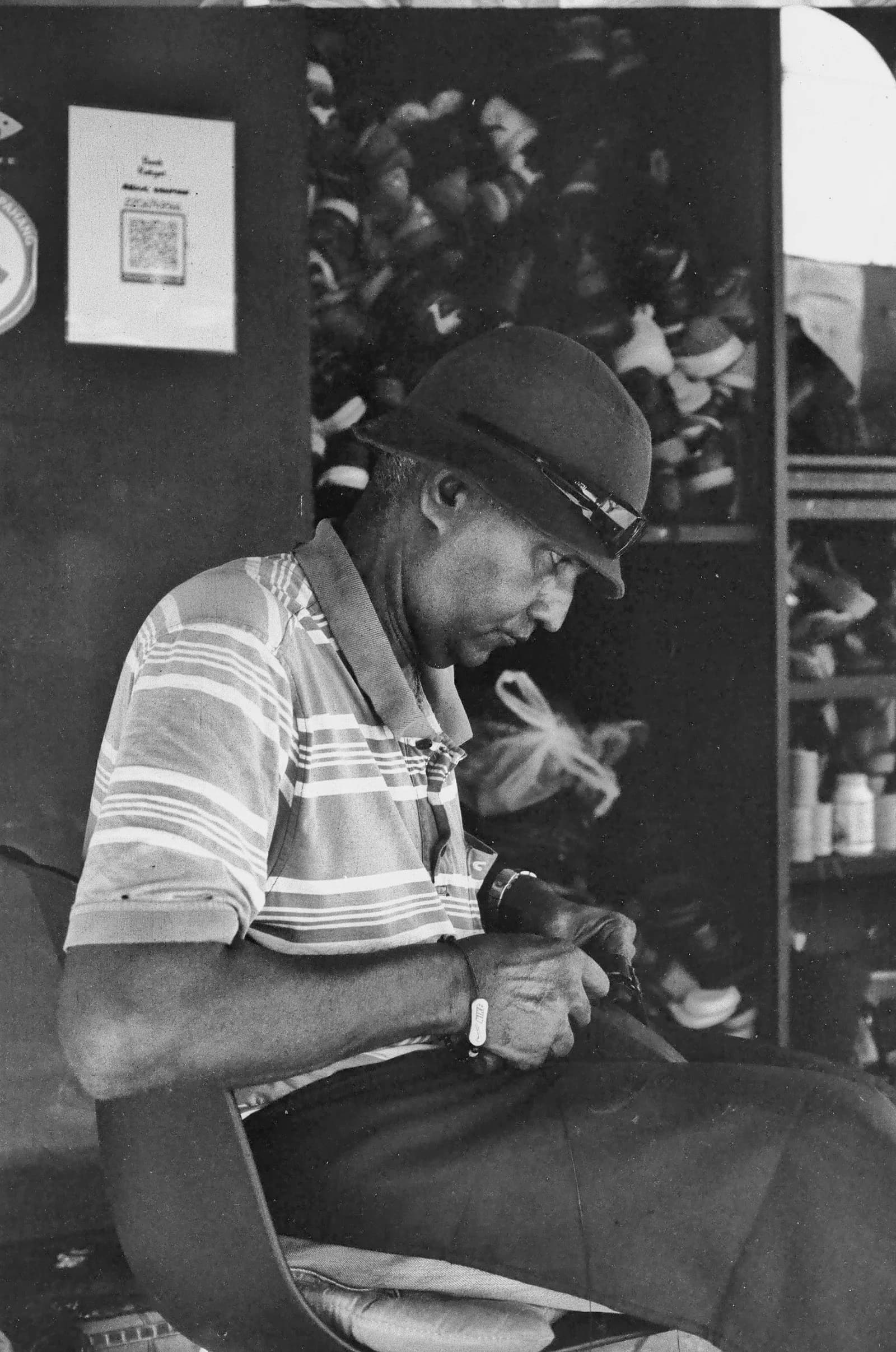 Documentary monochrome photograph of a person absorbed in skilled work