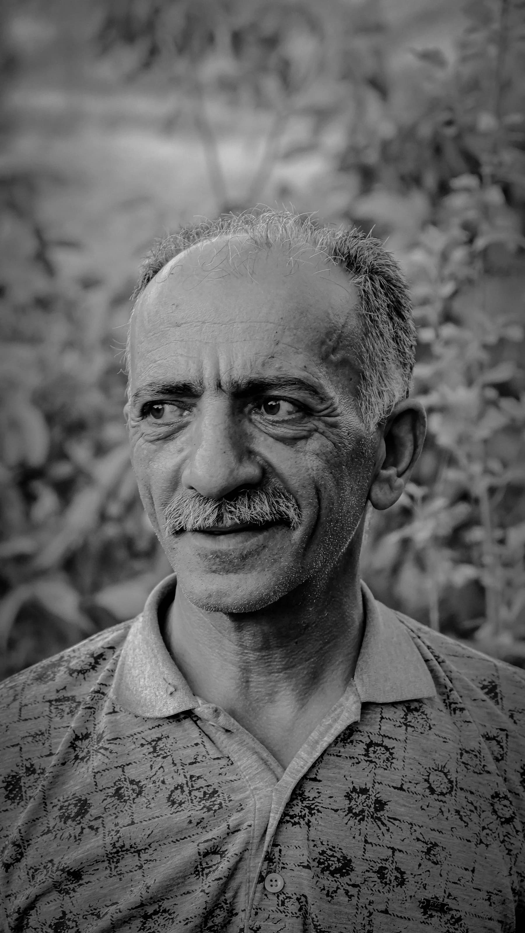 Monochrome portrait of a mature person with a calm, conscious gaze