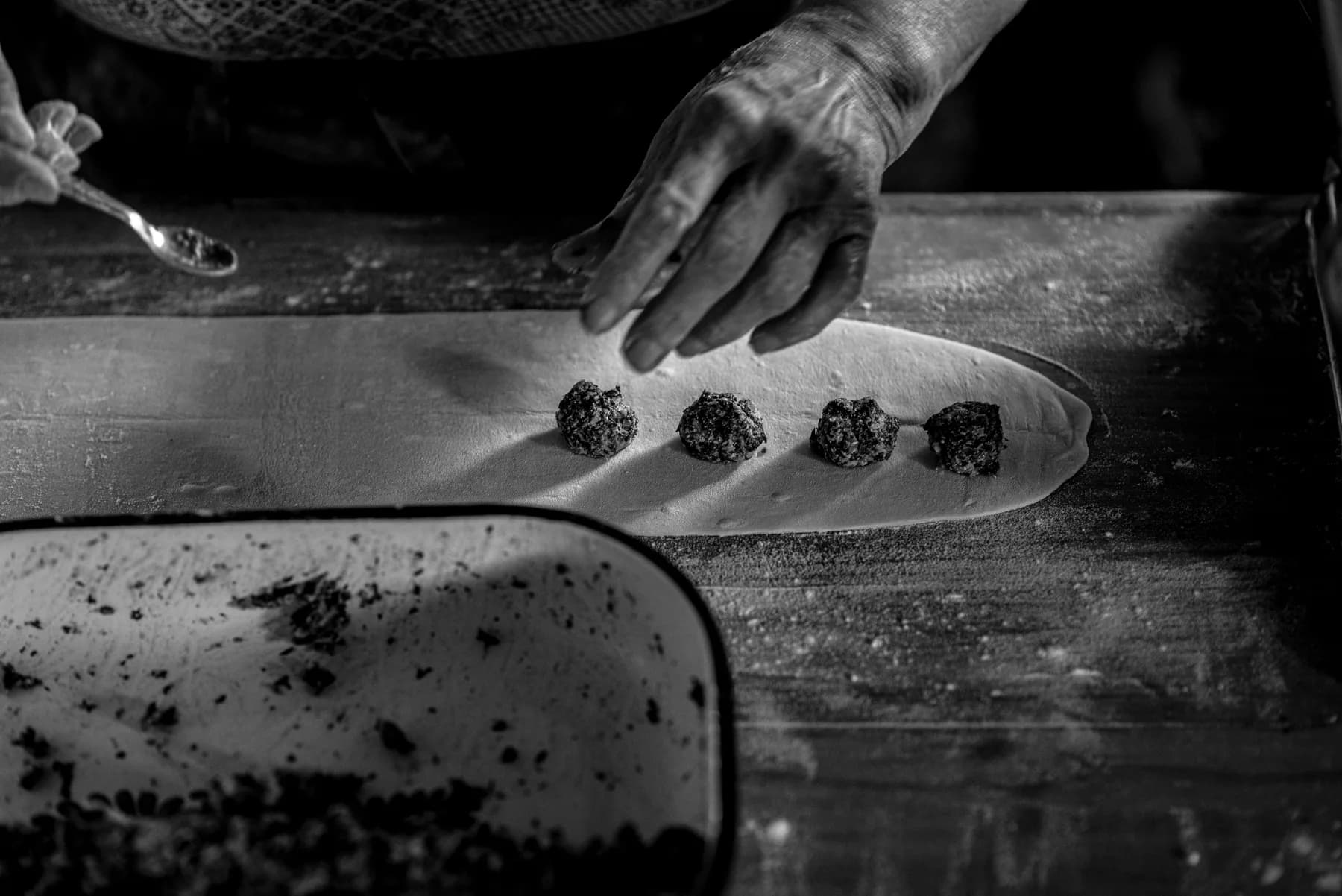 Monochrome detail of experienced hands preparing food